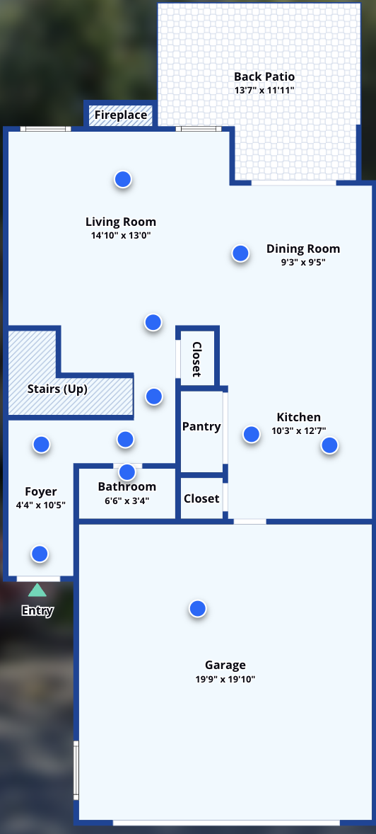 Main level floor plan with the entry, foyer, living room with fireplace, dining room, kitchen, pantry, bathroom, and two-car garage