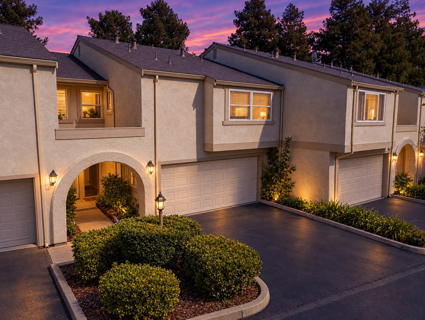 5352 Port Sailwood Drive illuminated at twilight, with landscaped entry and two-car garage